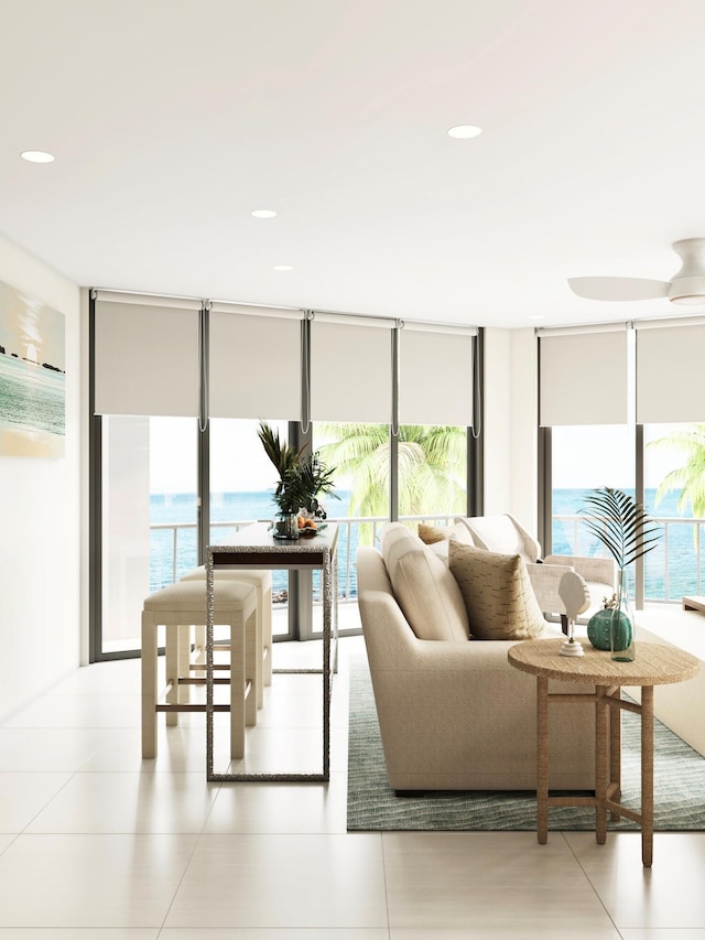 living area featuring a wall of windows and recessed lighting