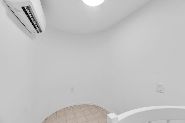 details with baseboards and a wall mounted air conditioner