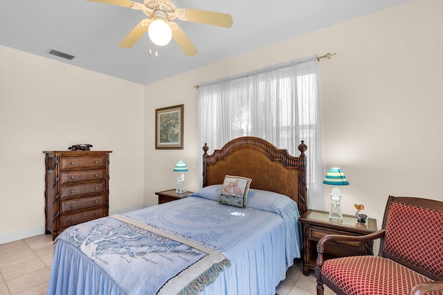 bedroom featuring a ceiling fan, visible vents, baseboards, and light tile patterned floors