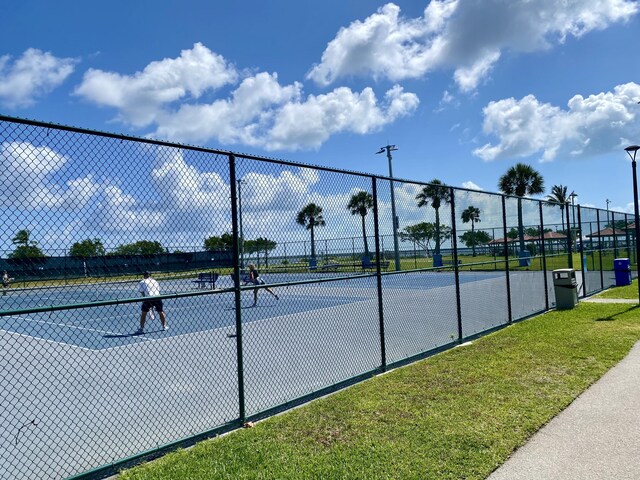 view of tennis court with fence