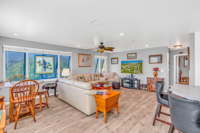 living room featuring a healthy amount of sunlight, light wood-style floors, visible vents, and recessed lighting