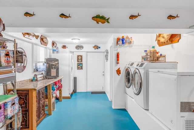 laundry room featuring washing machine and dryer and laundry area