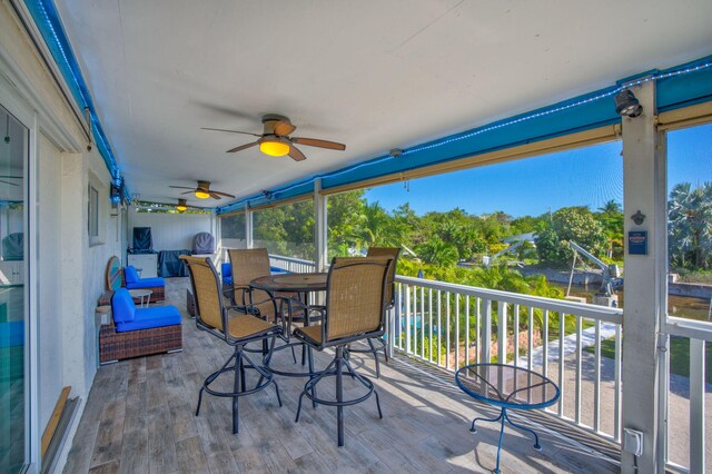 wooden deck with a ceiling fan