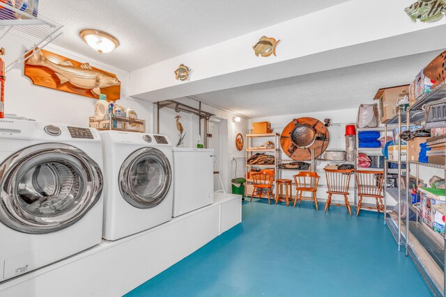 laundry area with laundry area, separate washer and dryer, and a textured ceiling