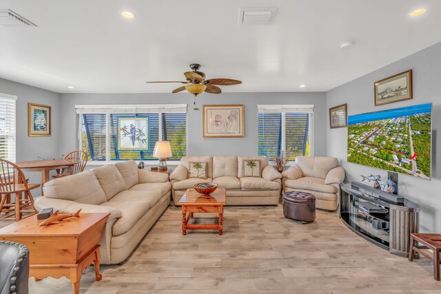 living room featuring ceiling fan, visible vents, wood finished floors, and recessed lighting