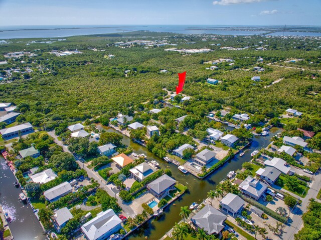 drone / aerial view with a water view and a residential view