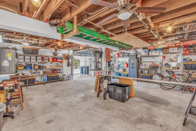 garage featuring a workshop area and electric water heater