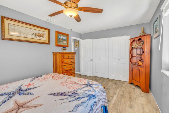 bedroom with baseboards, a closet, visible vents, and light wood-style floors