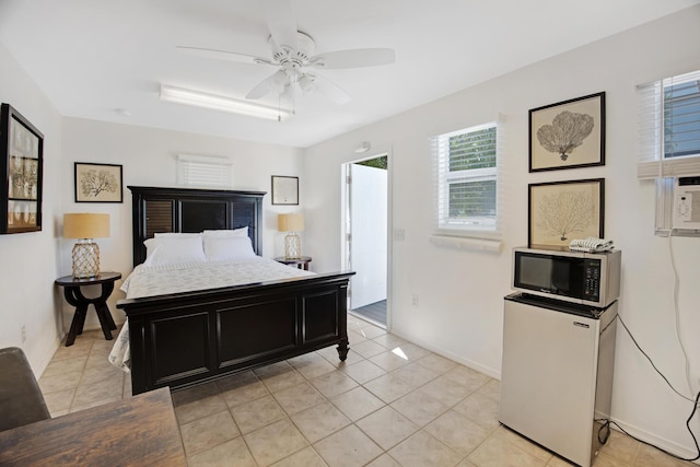 bedroom with freestanding refrigerator, light tile patterned flooring, ceiling fan, and baseboards