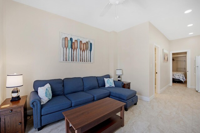 living area with recessed lighting, a ceiling fan, and baseboards