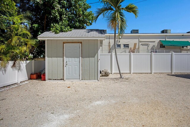 view of shed featuring fence