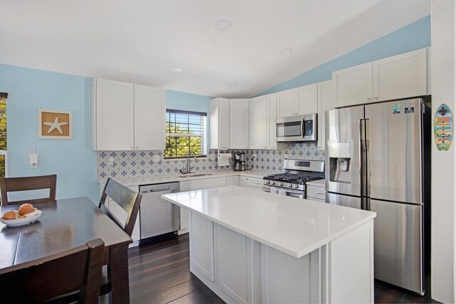 kitchen with appliances with stainless steel finishes, light countertops, white cabinets, and a sink