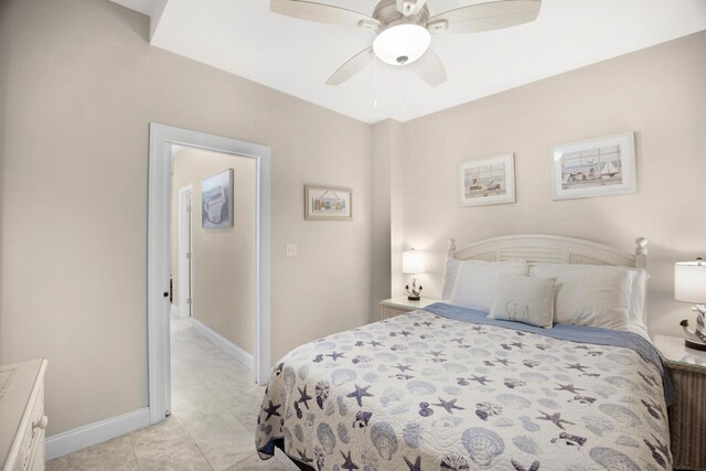 bedroom featuring ceiling fan, baseboards, and light tile patterned floors