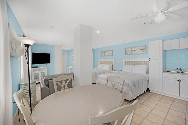 bedroom featuring light tile patterned floors, a ceiling fan, a sink, and recessed lighting