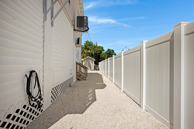 view of side of home featuring crawl space and fence