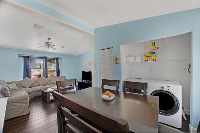 dining space featuring visible vents, dark wood finished floors, a ceiling fan, lofted ceiling, and washing machine and dryer