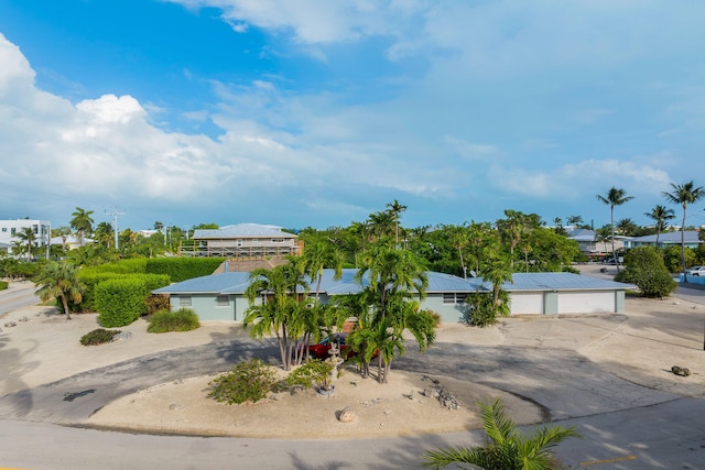 1103 Indies Dr, Duck, FL 33050 - view of front facade with metal roof and a detached garage
