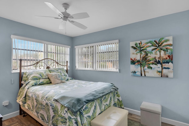 1103 Indies Dr, Duck, FL 33050 - bedroom featuring baseboards, multiple windows, ceiling fan, and wood finished floors