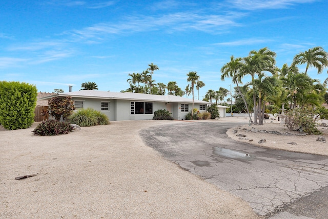 1103 Indies Dr, Duck, FL 33050 - ranch-style house featuring asphalt driveway and stucco siding