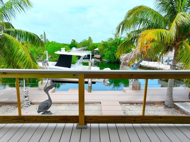 1590 Dolphin Dr, Marathon, FL 33050 - wooden deck featuring boat lift, a water view, and a boat dock
