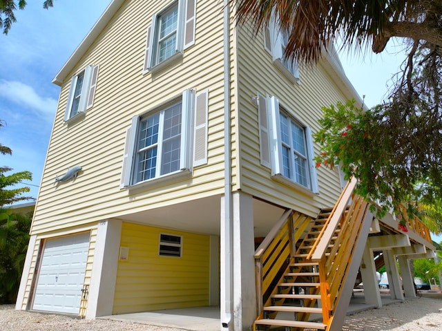 1590 Dolphin Dr, Marathon, FL 33050 - view of side of home with a carport, stairway, and a garage