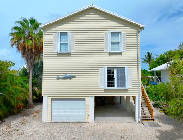 1590 Dolphin Dr, Marathon, FL 33050 - exterior space with a garage, dirt driveway, stairway, and a carport