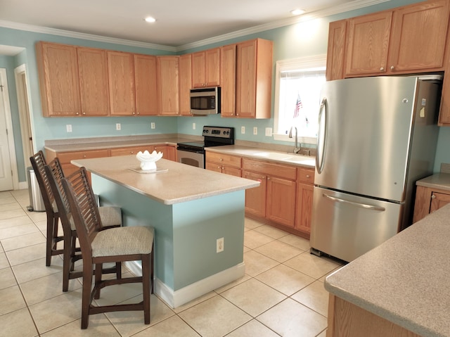 1590 Dolphin Dr, Marathon, FL 33050 - kitchen featuring stainless steel appliances, light tile patterned floors, a center island, light countertops, and a kitchen bar