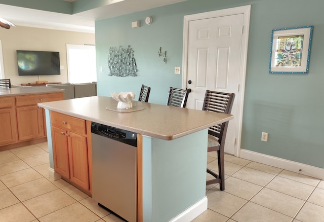 1590 Dolphin Dr, Marathon, FL 33050 - kitchen featuring dishwasher, light tile patterned flooring, a kitchen bar, light countertops, and a center island