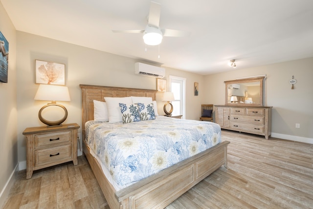 11282 2nd Ave, Ocean, Marathon, FL 33050 - bedroom featuring baseboards, an AC wall unit, a ceiling fan, and light wood finished floors