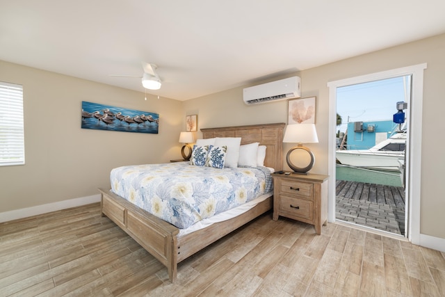 11282 2nd Ave, Ocean, Marathon, FL 33050 - bedroom featuring an AC wall unit, light wood-style floors, ceiling fan, and baseboards