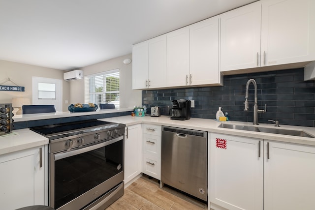 11282 2nd Ave, Ocean, Marathon, FL 33050 - kitchen with a wall unit AC, decorative backsplash, a sink, white cabinets, and appliances with stainless steel finishes
