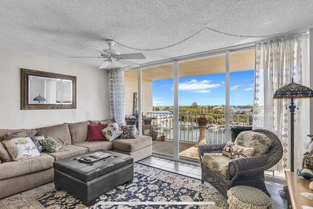 2000 Coco Plum Dr Unit 603, Marathon, FL 33050 - tiled living area with a water view, ceiling fan, and a wall of windows