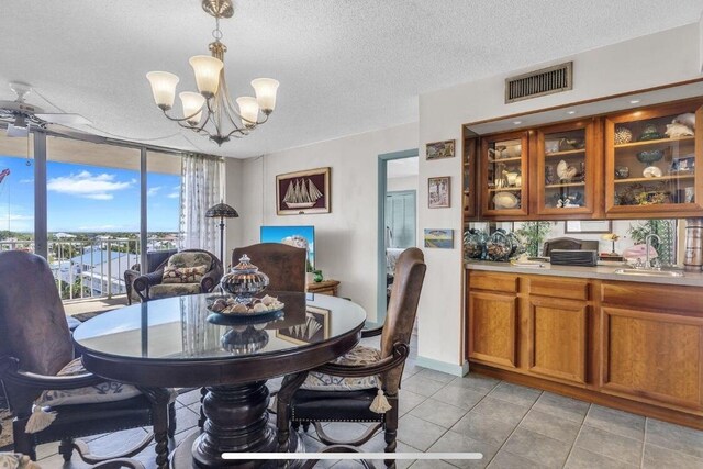 2000 Coco Plum Dr Unit 603, Marathon, FL 33050 - dining room with a chandelier, light tile patterned floors, and a textured ceiling