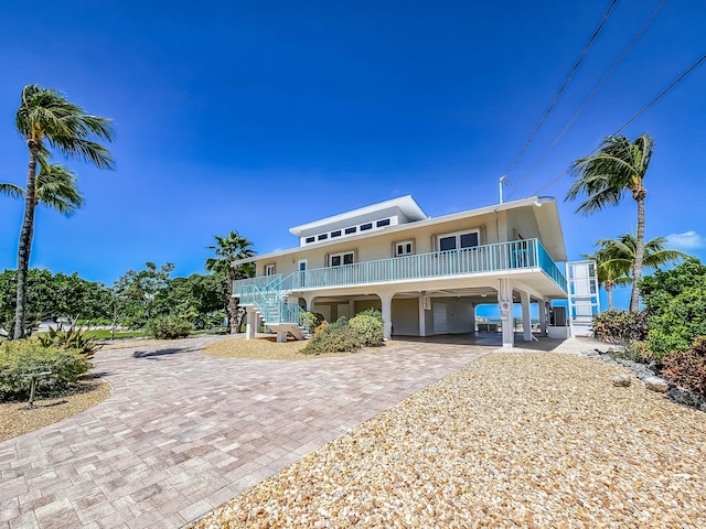 359 Stirrup Key Blvd, Marathon, FL 33050 - raised beach house featuring a carport, stairs, decorative driveway, and stucco siding