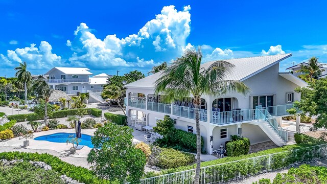 359 Stirrup Key Blvd, Marathon, FL 33050 - back of property with stucco siding, stairs, a fenced backyard, and a patio