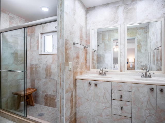359 Stirrup Key Blvd, Marathon, FL 33050 - bathroom featuring a stall shower, double vanity, and tile walls