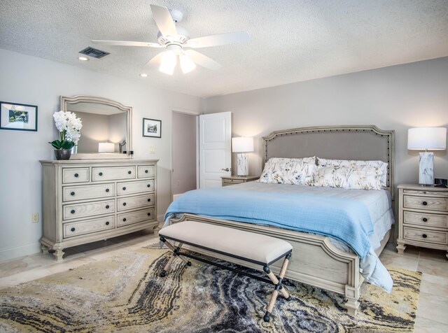 bedroom with a textured ceiling, visible vents, a ceiling fan, and baseboards