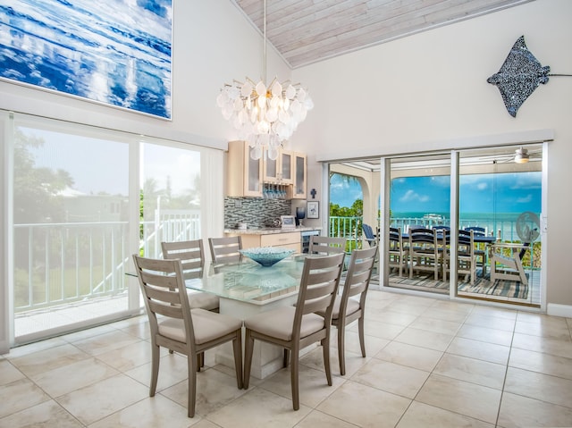 dining space featuring high vaulted ceiling, a chandelier, and light tile patterned flooring