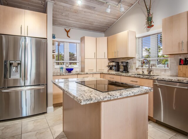 kitchen with lofted ceiling, wooden ceiling, appliances with stainless steel finishes, a sink, and backsplash