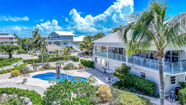 pool featuring a patio and a residential view