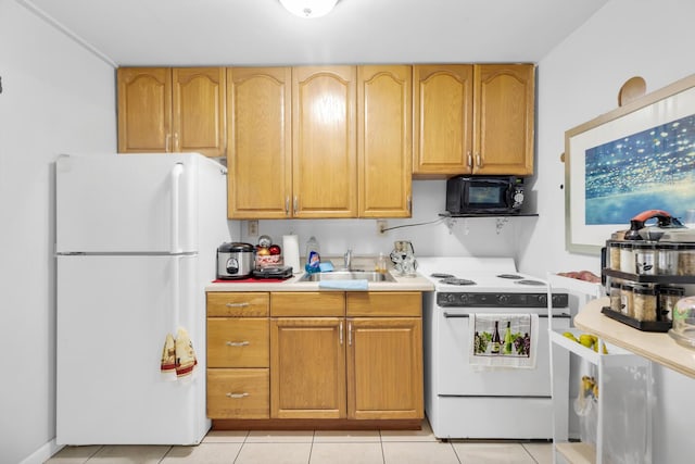 kitchen with a sink, white appliances, light tile patterned floors, and light countertops