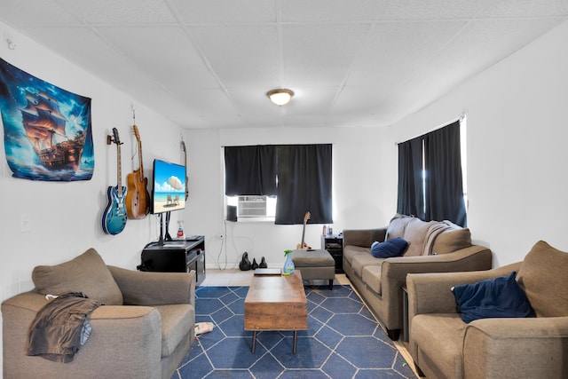 living room with cooling unit and a paneled ceiling