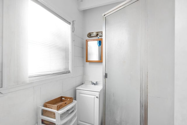 bathroom featuring a stall shower and vanity