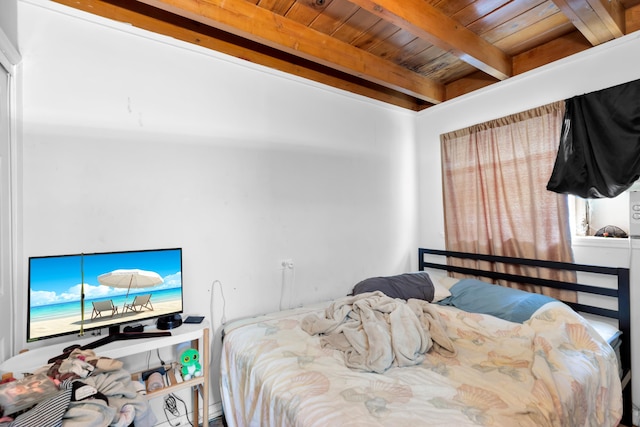 bedroom featuring beamed ceiling and wood ceiling