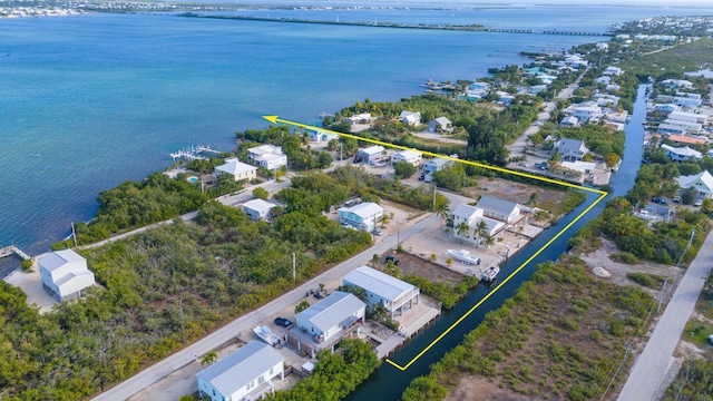 drone / aerial view with a water view and a residential view