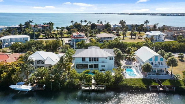 drone / aerial view featuring a residential view and a water view
