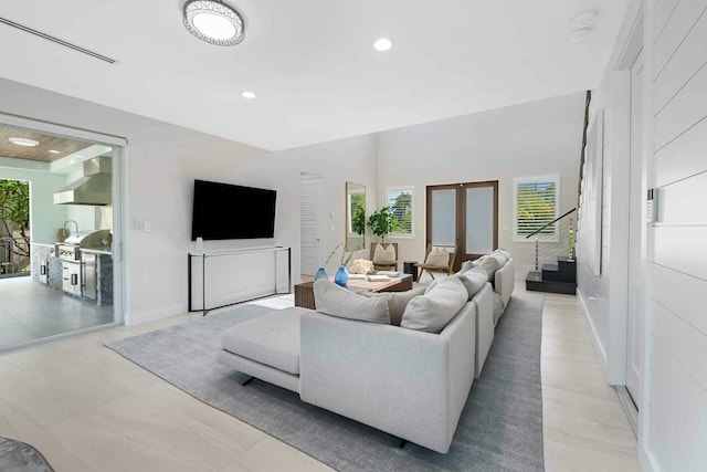 living area featuring visible vents, recessed lighting, french doors, and baseboards