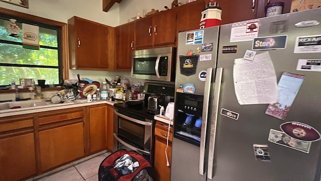 20 Park Rd, Islamorada, FL 33036 - kitchen featuring appliances with stainless steel finishes, light countertops, light tile patterned floors, and brown cabinets