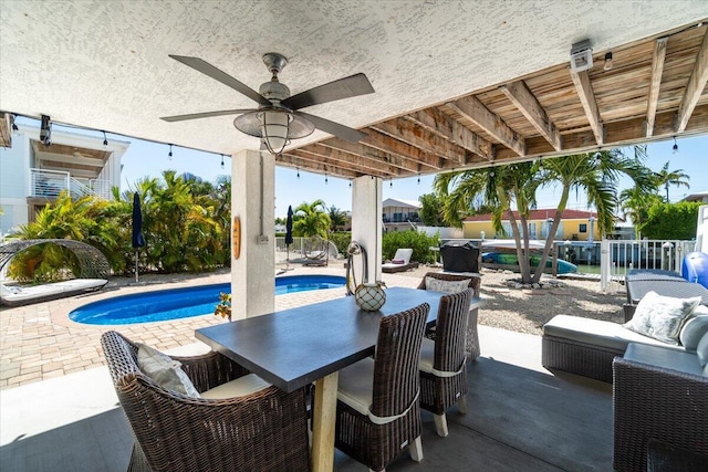 219 Sombrero Beach Rd Unit 2, Marathon, FL 33050 - view of patio with a fenced in pool, a fenced backyard, outdoor dining space, and a ceiling fan