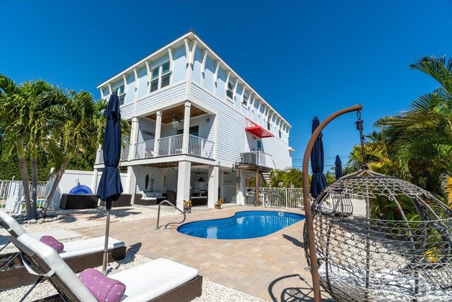 219 Sombrero Beach Rd Unit 2, Marathon, FL 33050 - back of house featuring a balcony, a fenced in pool, a fenced backyard, outdoor lounge area, and a patio area